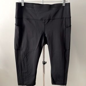 Lululemon black s12 cropped leggings with double vented side pockets. 16” length